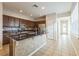 An open eat-in kitchen is furnished with an island and stainless steel appliances at 32717 Coldwater Creek Loop, Wesley Chapel, FL 33545