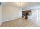 Living room with kitchen view, tile floors, and ample space at 32717 Coldwater Creek Loop, Wesley Chapel, FL 33545