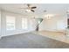 Bright and spacious living room featuring carpet and tile flooring at 32717 Coldwater Creek Loop, Wesley Chapel, FL 33545