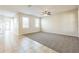 Open-concept living area with carpet and tile flooring at 32717 Coldwater Creek Loop, Wesley Chapel, FL 33545