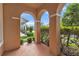 Covered front porch with a view of the street and nearby houses at 32717 Coldwater Creek Loop, Wesley Chapel, FL 33545