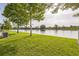 Manicured lawn leading to picturesque view of a serene lake at 5254 Suncatcher Dr, Wesley Chapel, FL 33545