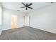 Spacious bedroom featuring neutral walls, plush carpeting, and a ceiling fan at 5254 Suncatcher Dr, Wesley Chapel, FL 33545