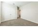 A bedroom with light gray walls, carpet flooring, and white doors at 5254 Suncatcher Dr, Wesley Chapel, FL 33545
