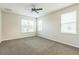 Bright bedroom with neutral walls, three windows, and a ceiling fan at 5254 Suncatcher Dr, Wesley Chapel, FL 33545
