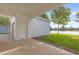 Exterior of home with lawn overlooking a lake and tree at 5254 Suncatcher Dr, Wesley Chapel, FL 33545