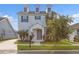 Two-story home featuring a charming front entrance, manicured lawn, and dormer windows at 5254 Suncatcher Dr, Wesley Chapel, FL 33545