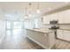 Open-concept kitchen featuring granite countertops, stainless appliances, and modern lighting at 5254 Suncatcher Dr, Wesley Chapel, FL 33545