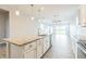 Open kitchen with granite counters, a center island, stainless steel appliances, and wood look tile at 5254 Suncatcher Dr, Wesley Chapel, FL 33545