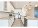 Bright kitchen featuring white cabinetry, stainless appliances, and granite countertops at 5254 Suncatcher Dr, Wesley Chapel, FL 33545