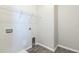 The laundry room features wood-look flooring and a wire rack shelf at 5254 Suncatcher Dr, Wesley Chapel, FL 33545
