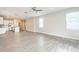 Spacious living room featuring an open floorplan and modern light-gray floors at 5254 Suncatcher Dr, Wesley Chapel, FL 33545