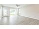 Open-concept living room with sliding glass doors leading to a patio and backyard at 5254 Suncatcher Dr, Wesley Chapel, FL 33545