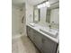 Bright bathroom featuring double sink vanity and walk-in shower at 7310 Sunshine Skyway S Ln # 116, St Petersburg, FL 33711