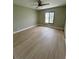 Bright bedroom with ceiling fan, modern flooring, a neutral paint palette, and natural light from the window at 7310 Sunshine Skyway S Ln # 116, St Petersburg, FL 33711