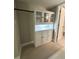 Well-lit walk-in closet with custom shelving and built-in storage cabinet at 7310 Sunshine Skyway S Ln # 116, St Petersburg, FL 33711