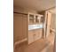 Bright walk-in closet with custom shelving and cabinet storage near bathroom at 7310 Sunshine Skyway S Ln # 116, St Petersburg, FL 33711