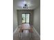 Dining room with modern light fixture and views through window at 7310 Sunshine Skyway S Ln # 116, St Petersburg, FL 33711