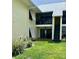 Exterior view of a two-story residential building with a lush green lawn and modern architectural design at 7310 Sunshine Skyway S Ln # 116, St Petersburg, FL 33711