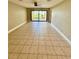 Large living area with tile flooring and sliding glass doors to the outside at 7310 Sunshine Skyway S Ln # 116, St Petersburg, FL 33711