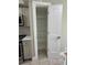 Pantry closet with multiple shelves and a white paneled door at 7310 Sunshine Skyway S Ln # 116, St Petersburg, FL 33711
