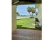 View from tiled patio to grass yard with pool, landscaping and waterway at 7310 Sunshine Skyway S Ln # 116, St Petersburg, FL 33711