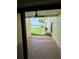 Inviting patio view showcasing patterned brick, lush green lawn, tropical palms, and tranquil water views at 7310 Sunshine Skyway S Ln # 116, St Petersburg, FL 33711