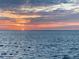 Scenic water view featuring a vibrant sunrise reflecting off the water, creating a tranquil atmosphere at 7310 Sunshine Skyway S Ln # 116, St Petersburg, FL 33711