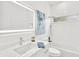 Bright bathroom featuring a vanity sink, toilet, and shower-tub combo at 9555 Knightsbridge Cir, Sarasota, FL 34238