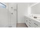 Bright bathroom featuring a walk-in shower with glass door and a double sink vanity with modern fixtures at 9555 Knightsbridge Cir, Sarasota, FL 34238