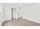 Bright bedroom featuring a ceiling fan, wood floors, and a closet with sliding doors at 9555 Knightsbridge Cir, Sarasota, FL 34238
