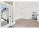 Bright, modern foyer with a view of the open-concept design, stainless steel appliances, and tile flooring at 9555 Knightsbridge Cir, Sarasota, FL 34238