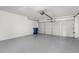 Spacious two car garage with high ceilings and painted floors at 9555 Knightsbridge Cir, Sarasota, FL 34238