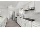 Bright kitchen with modern appliances, white cabinetry, and quartz countertops, creating a sleek and inviting space at 9555 Knightsbridge Cir, Sarasota, FL 34238
