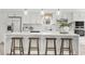 Kitchen featuring a large island with bar seating, sleek white cabinets, and modern stainless steel appliances at 9555 Knightsbridge Cir, Sarasota, FL 34238