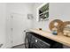 Laundry room featuring a front load washer and dryer, butcher block countertop, and exterior view at 9555 Knightsbridge Cir, Sarasota, FL 34238