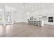 Spacious open-concept living room and kitchen with high ceilings and tile flooring, perfect for entertaining at 9555 Knightsbridge Cir, Sarasota, FL 34238