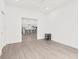 Open living room showcasing the modern flooring and a glimpse into the bright, open kitchen at 9555 Knightsbridge Cir, Sarasota, FL 34238