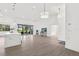 Bright and airy living area with an open layout, tiled floors, and a view of the screened-in patio and backyard at 9555 Knightsbridge Cir, Sarasota, FL 34238