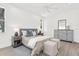 Comfortable main bedroom with a large bed, wood floors, and a view of the yard at 9555 Knightsbridge Cir, Sarasota, FL 34238
