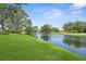 Scenic water view with lush green landscaping creating a tranquil and picturesque setting for relaxing and enjoying the outdoors at 9555 Knightsbridge Cir, Sarasota, FL 34238