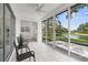 Sunroom features a ceiling fan, tile floors, and large sliding glass doors to outdoor view at 9555 Knightsbridge Cir, Sarasota, FL 34238
