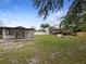 Large backyard with covered back porch and wooden structure at 103 4Th Nw Ave, Lutz, FL 33548