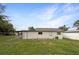 Exterior view of the house showing the backyard and back porch at 103 4Th Nw Ave, Lutz, FL 33548