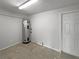 Unfinished basement featuring a hot water heater and concrete floor at 103 4Th Nw Ave, Lutz, FL 33548