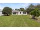 Quaint single-story home featuring a well-manicured front yard and carport at 103 4Th Nw Ave, Lutz, FL 33548