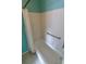 Bathroom showcasing a white tiled shower/tub combination with a shower curtain and grab bar at 1122 Montrose Pl # 1713, Dunedin, FL 34698