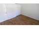 Bedroom featuring wood-look floors and closet at 1122 Montrose Pl # 1713, Dunedin, FL 34698