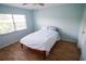 Bedroom featuring wood-look floors and light blue walls at 1122 Montrose Pl # 1713, Dunedin, FL 34698