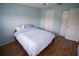Bedroom featuring wood-look floors and light blue walls at 1122 Montrose Pl # 1713, Dunedin, FL 34698